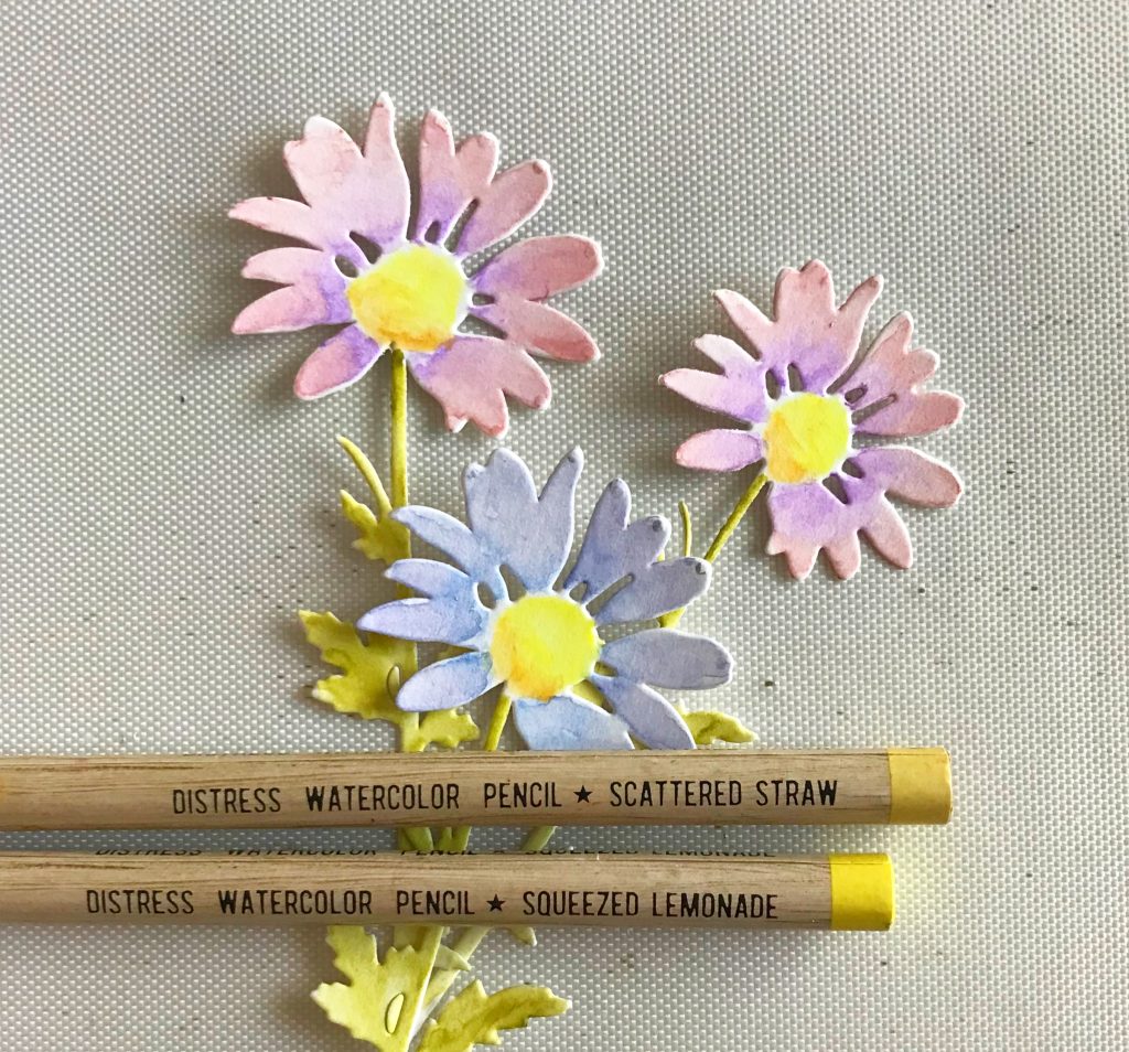 Photo showing the Distress Watercolor Pencils used to color the center of the flower die cuts for today’s post. 