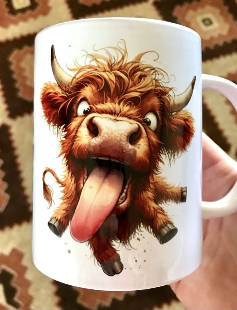 Photo of the finished 15 oz sublimated mug featuring one of the images from the Funny Highland Cows file from Creative Fabrica.