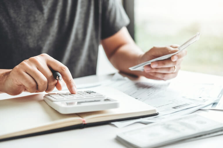 Man using calculator Accounting Calculating Cost Economic bills with