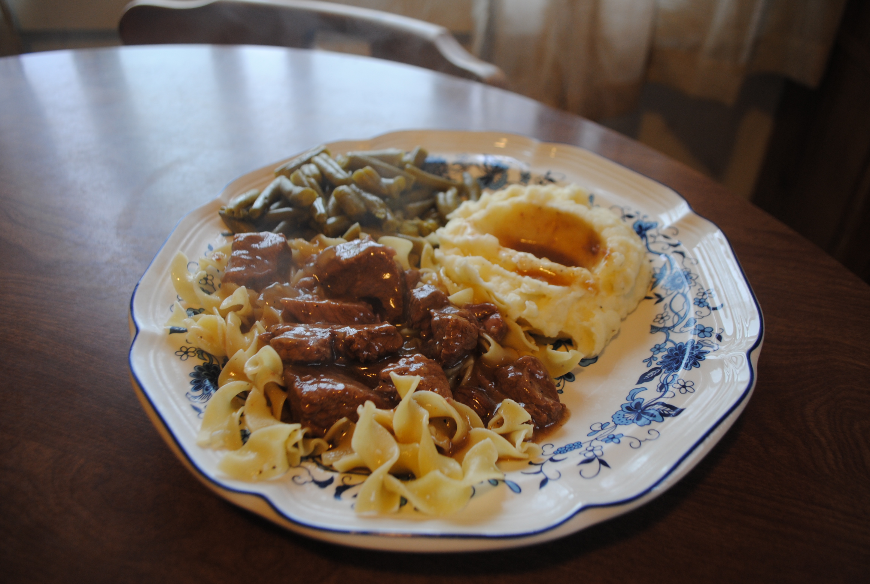 OLD TIME BEEF TIPS AND GRAVY OVER BUTTERED SEASONED NOODLES