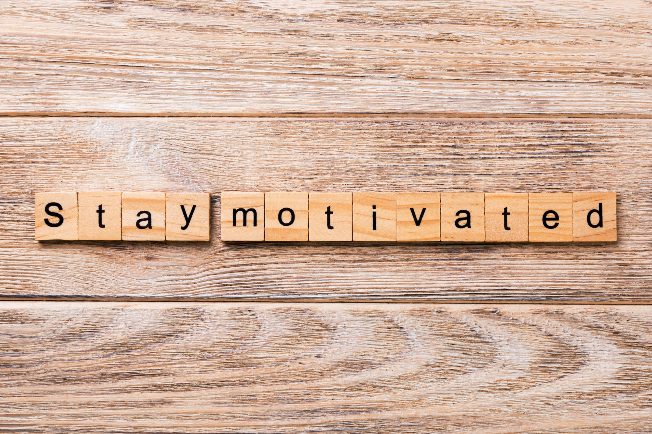 Stay motivated word written on wood block. Stay motivated text on