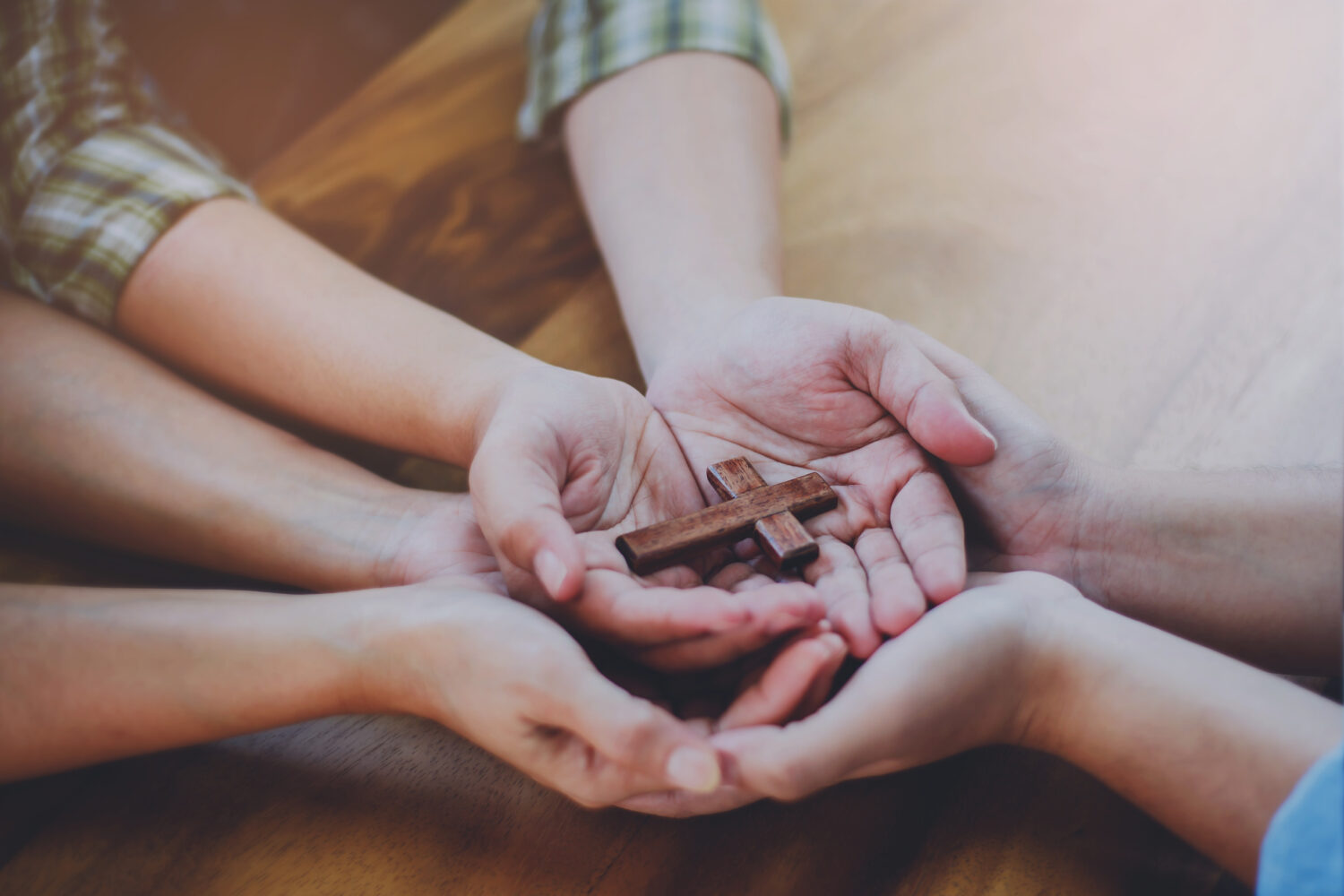 hands holding cross Cornerstone Christian Church