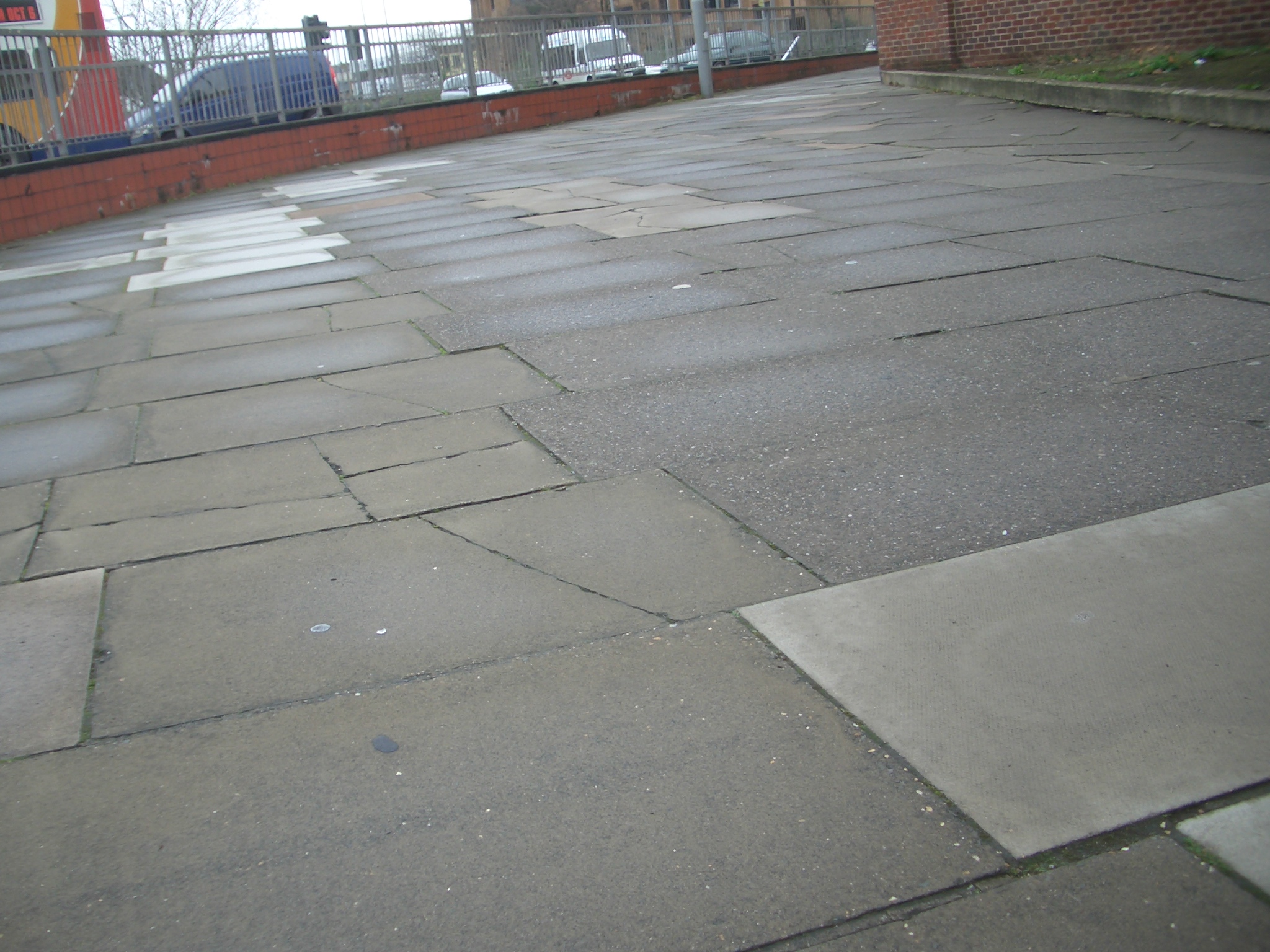 CycleStreets » Photo 9769 Cracked and uneven paving slabs on a