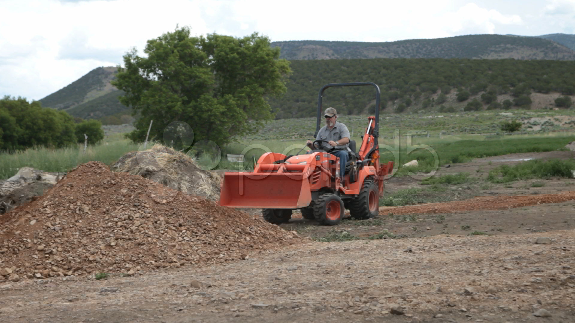 Small yard backhoe tractor moving dirt at new home P HD Footage 438343