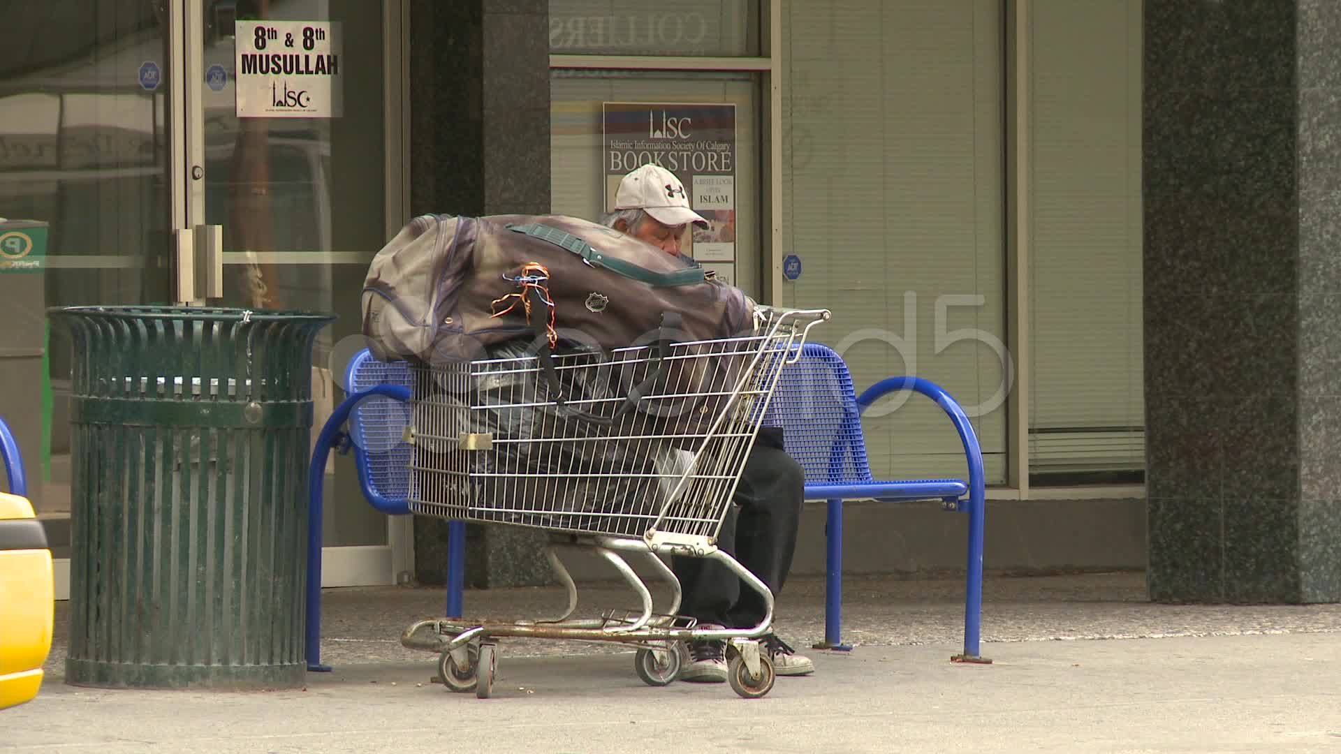 Homeless Man Sitting On A Bench With His Shopping Cart Stock Video