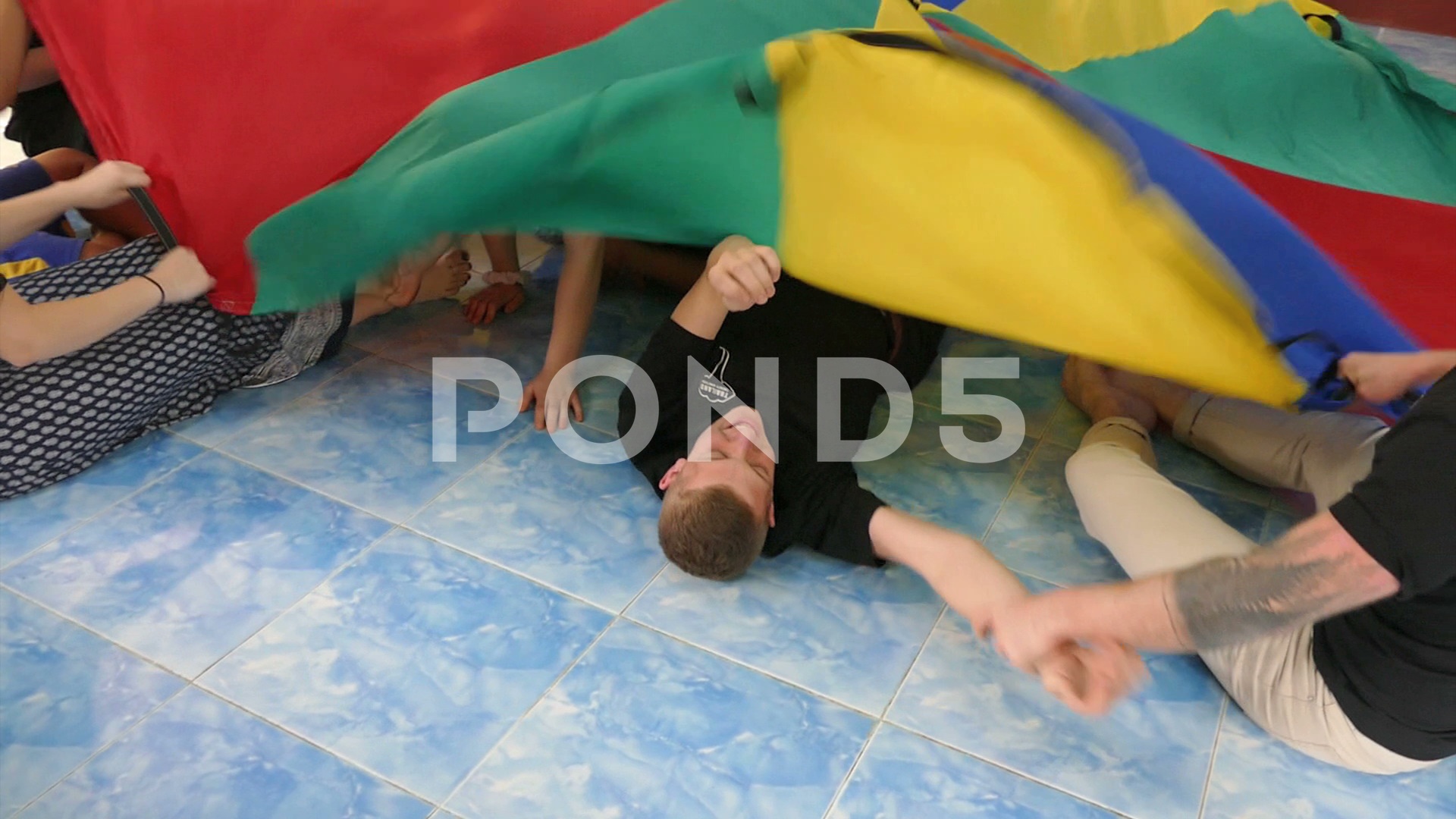 Kids Enjoying Crazy Parachute Games With High School Youth Missions