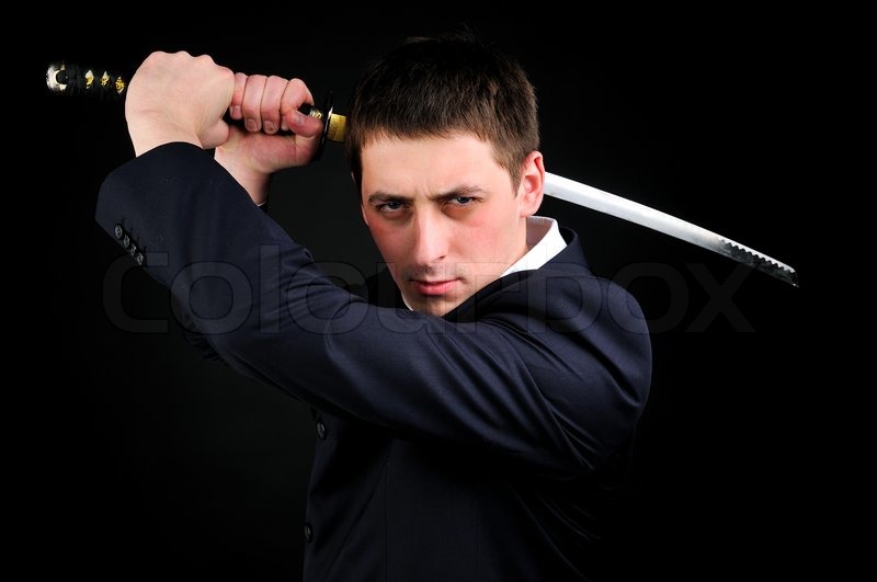 Young man hold sword Stock Photo Colourbox