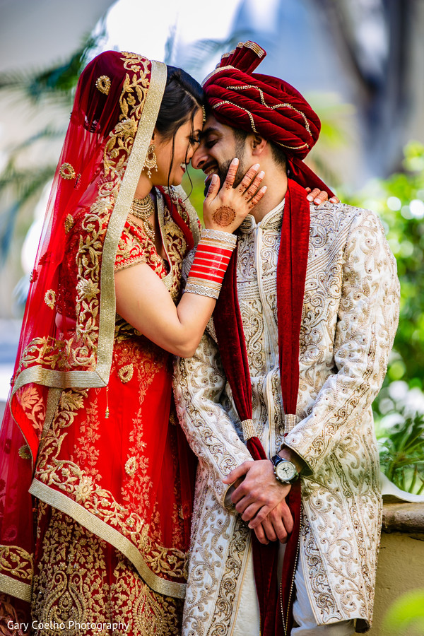 Adorable Indian bride being kissed by groom outdoor capture. Photo 190971