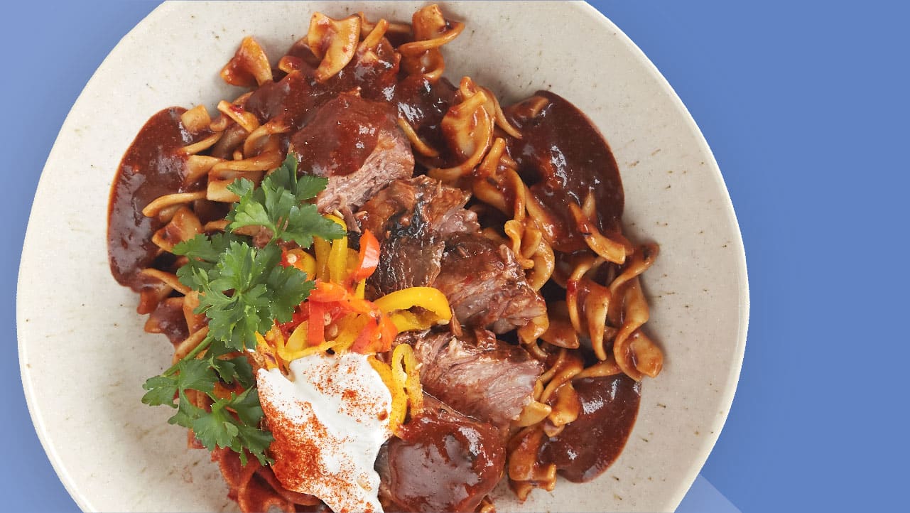 Beef Short Rib Goulash Over Egg Noodles With Grilled Peppers and Sour