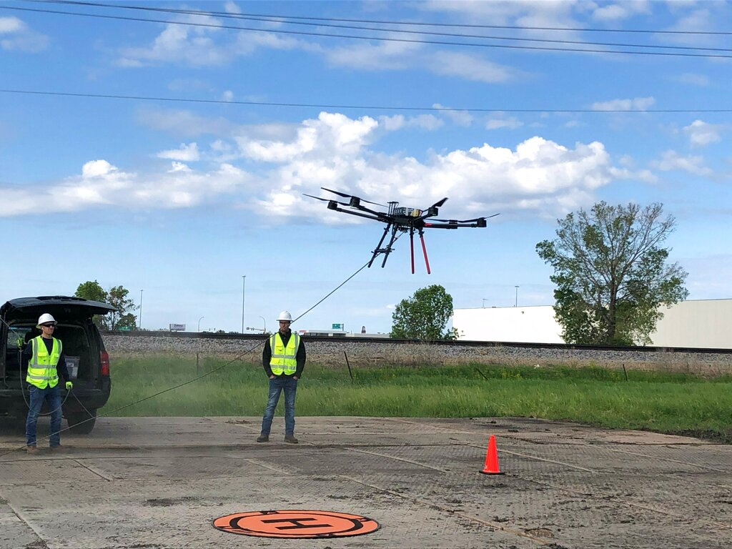 Utility using drones to build power lines