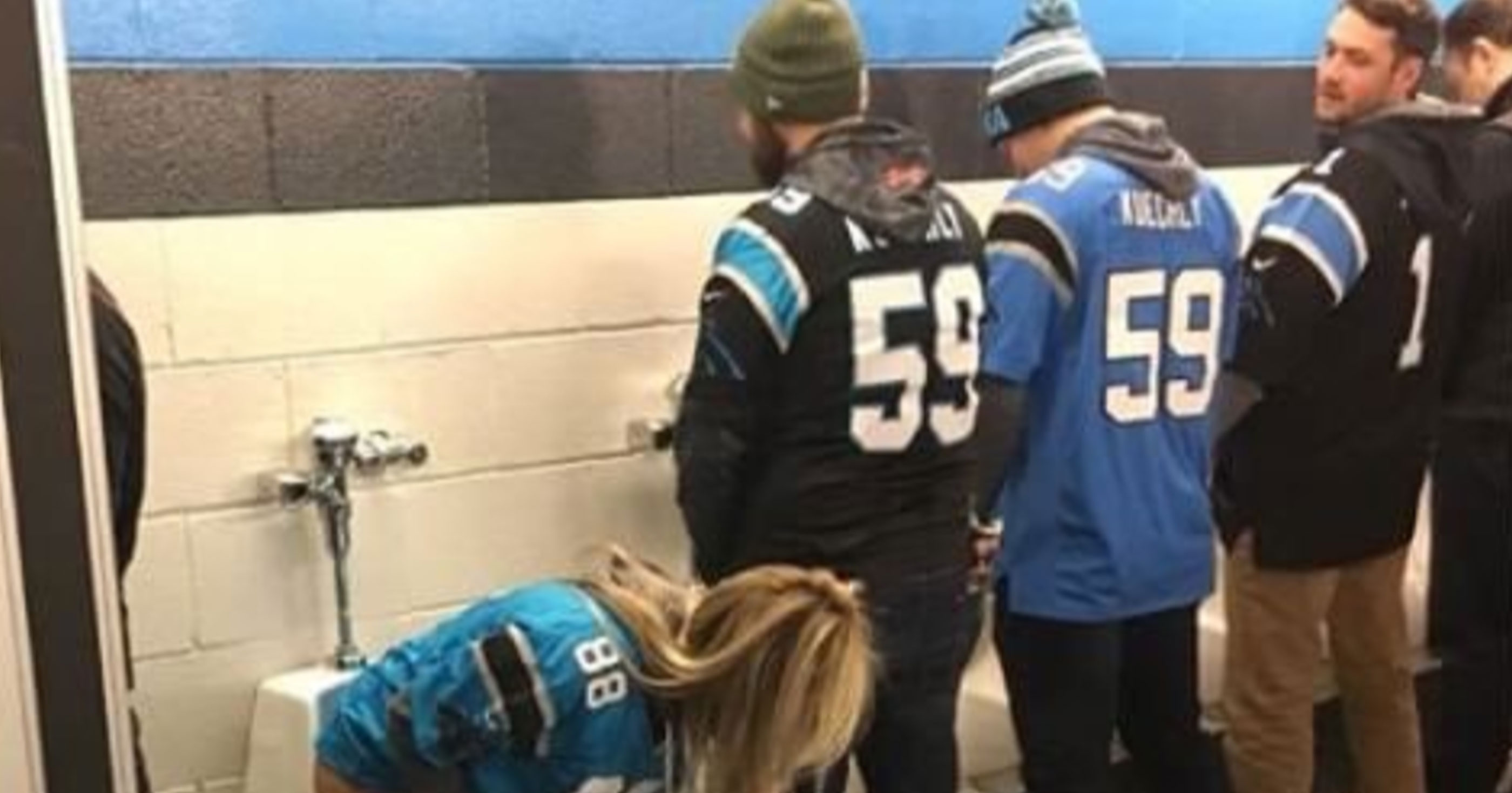 Female Carolina Panthers Fan Takes A Squat, Sits & Pees Into Men’s Urinal At Game
