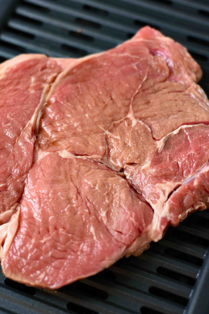 Raw meat on the grill.