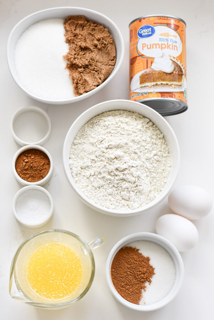 Ingredients gathered on a kitchen counter to make mini pumpkin muffins.