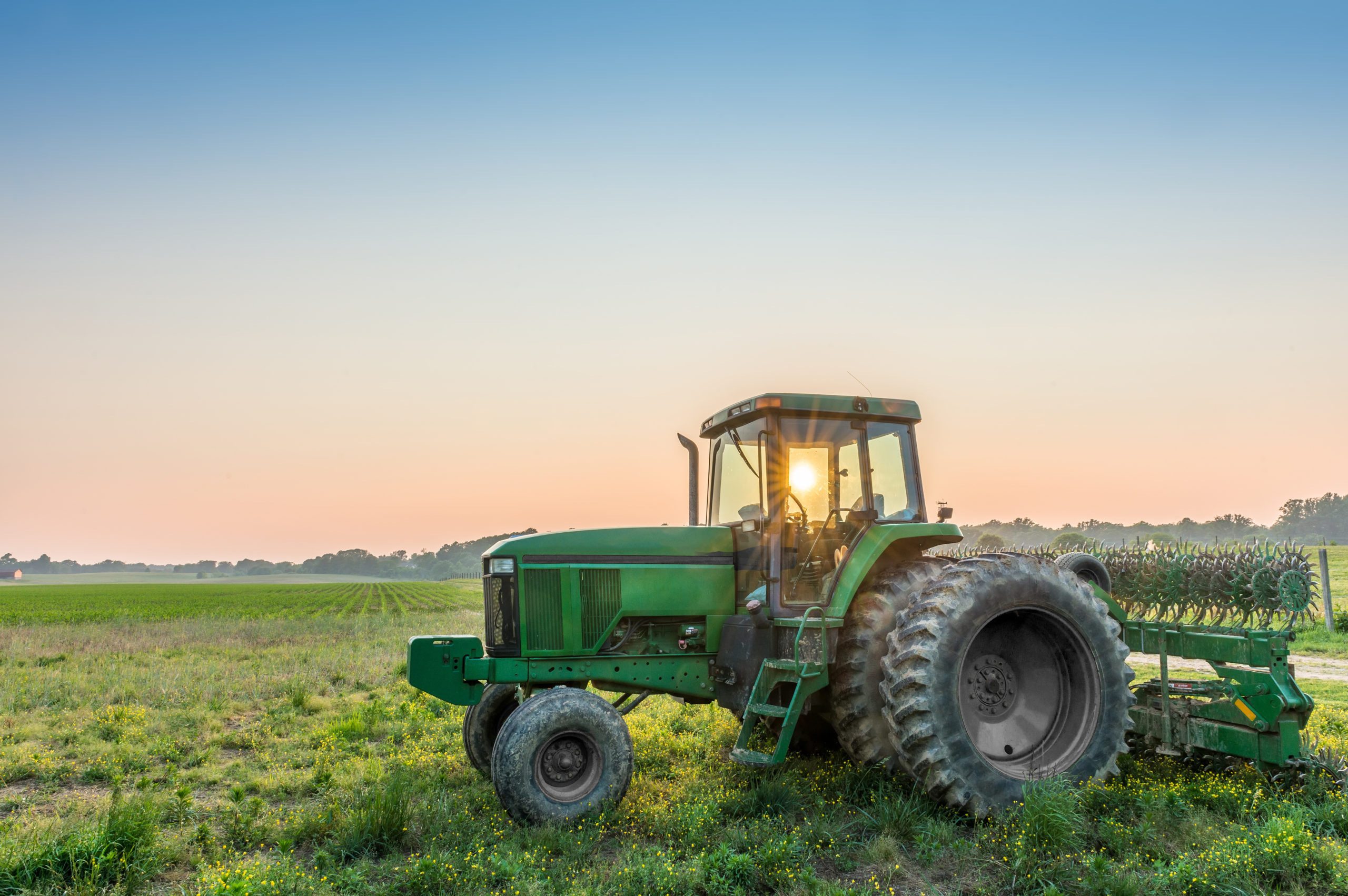 Tractor in a field on a Maryland Farm near sunset Dark Insurance