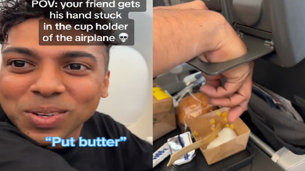 Video Curious man gets his hand gets stuck in airplane cup holder mid
