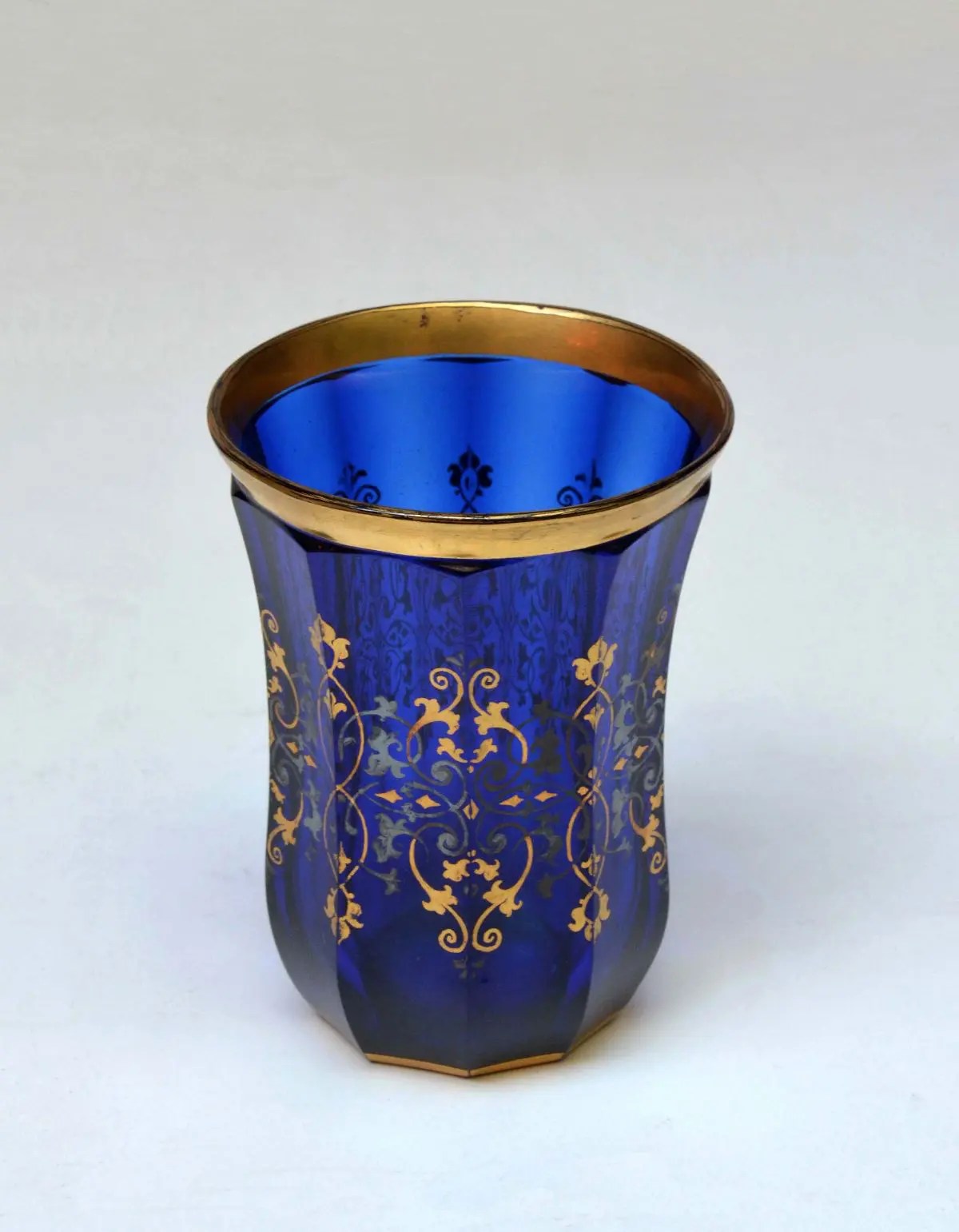 Blue cut glass ogee shaped Tumbler with silver and gilt decoration