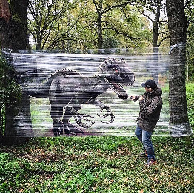 An Artist SprayPaint Animals On Plastic Wrap In The Forest With
