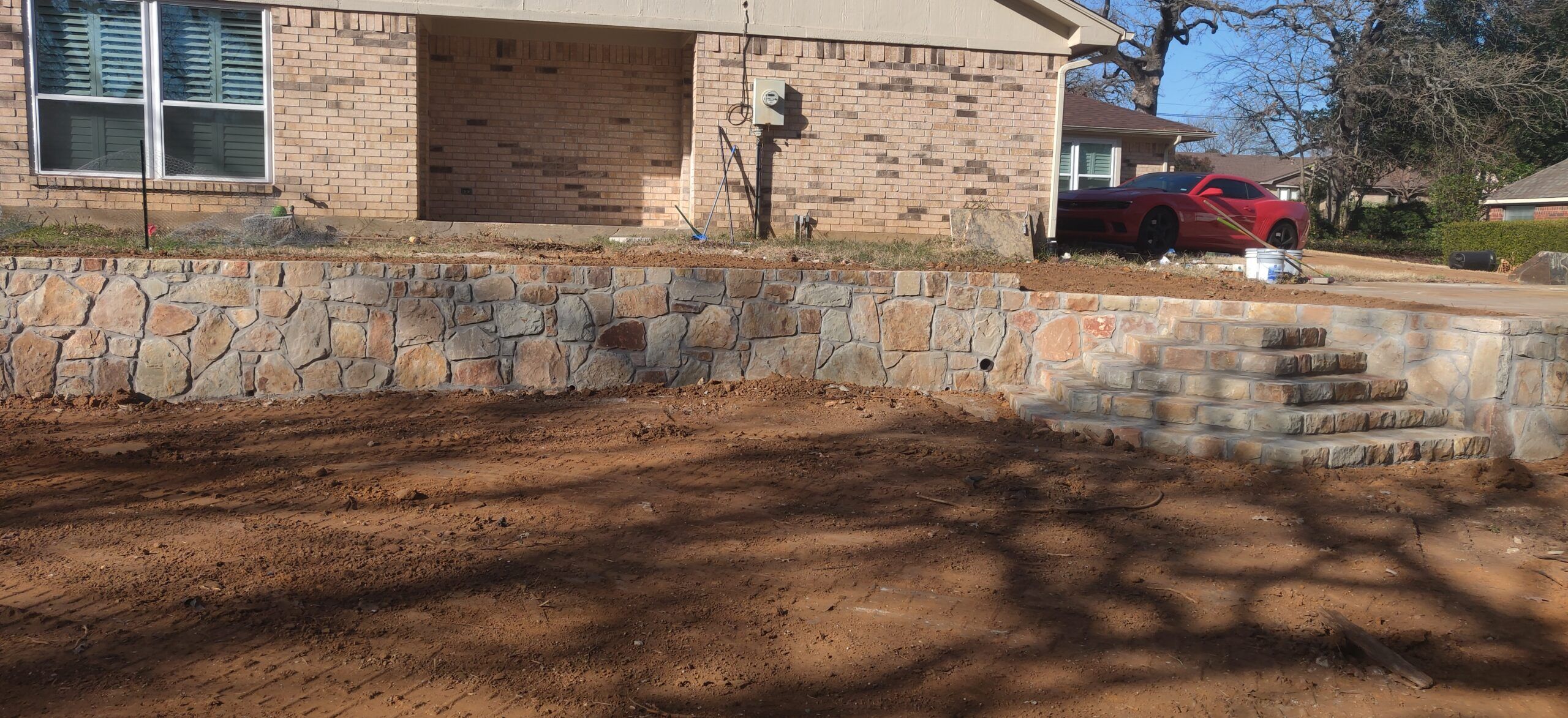 Excavated to level out yard to fix drainage issue and installed Milsap stone retaining wall and