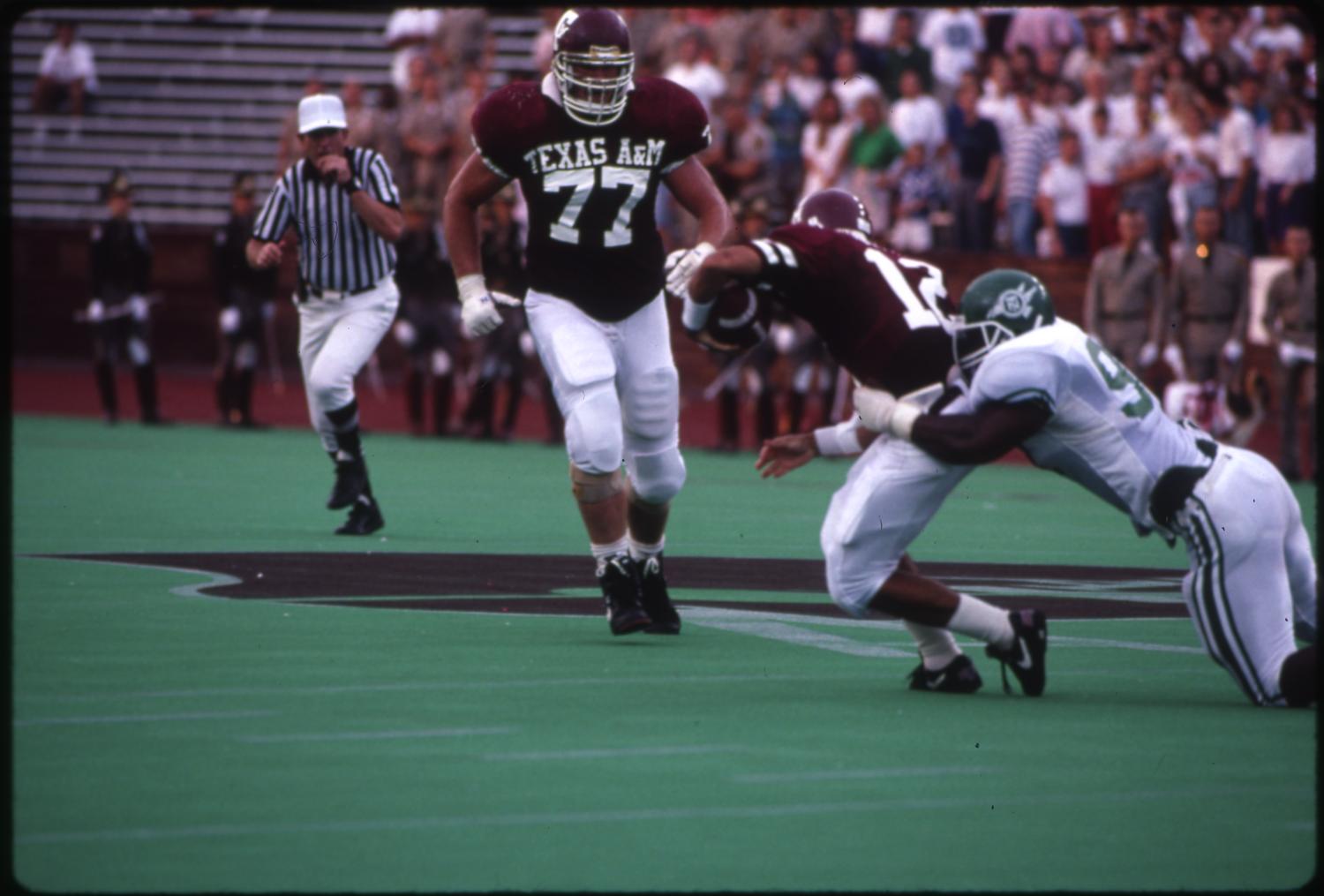 [North Texas Football Player Tackles an Aggie, 1991] UNT Digital Library