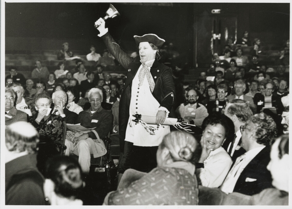 Town Crier, Steve Symonds, with a cell phone discoverywall.nz