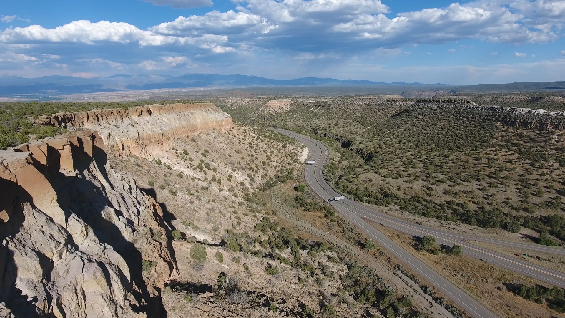 Aerial Drone Footage of New Mexico Canyons Along a Winding Highway Valley 2
