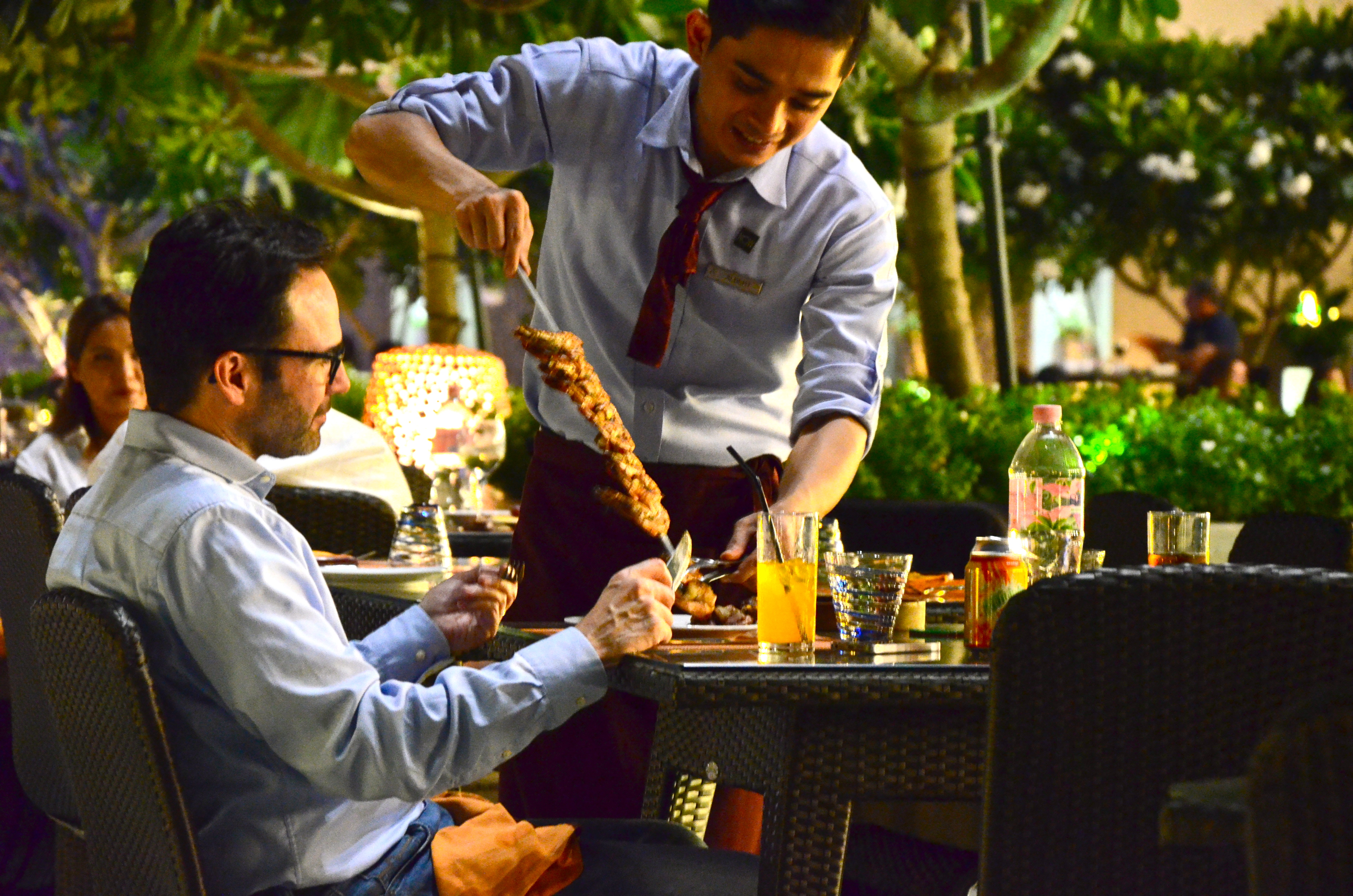 Grilled meat being delivered at the table