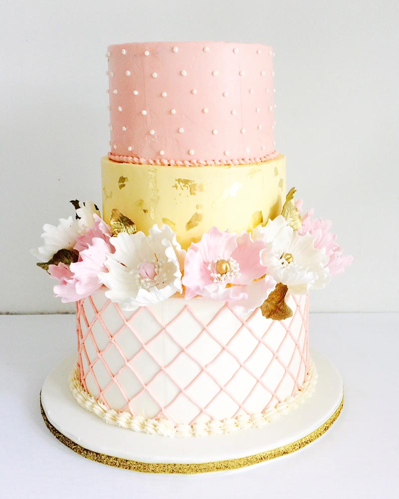 Buttercream tiered custom cake with sugar peonies and gold leaves as accents Ottawa Custom