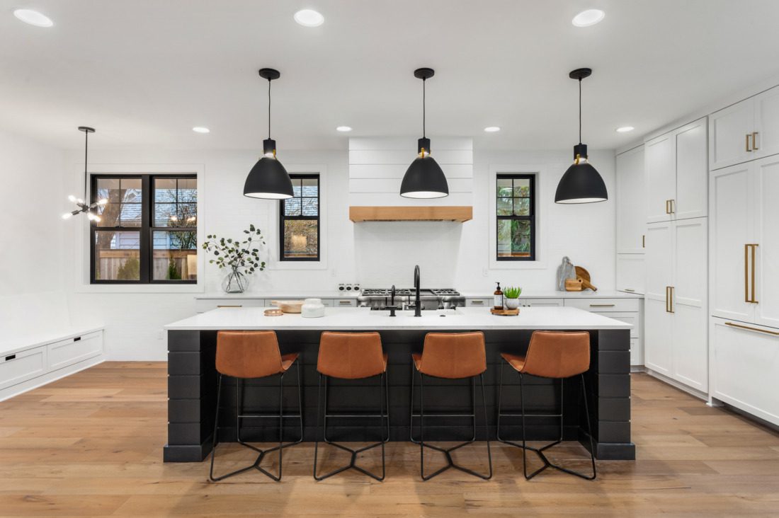 Beautiful white kitchen with dark accents in new modern farmhouse style