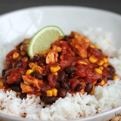 A plate of food with rice meat and vegetables