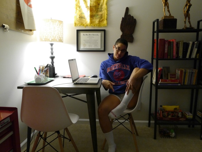 A person sitting at a desk in a small room