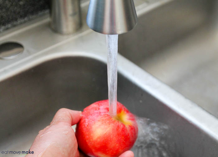 rinsing off an apple