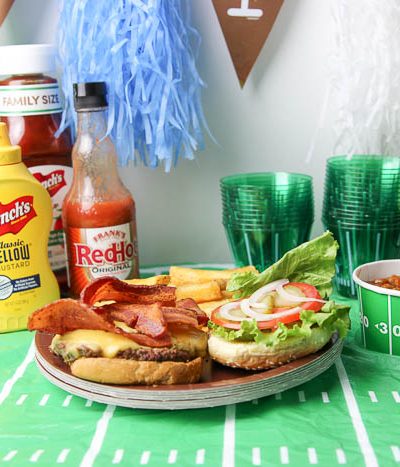 A hamburger and condiments on a table