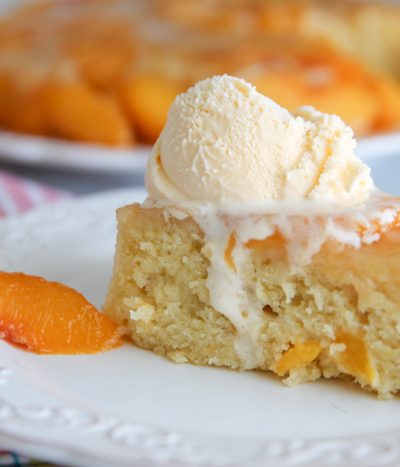 A close up of a slice of cake on a plate, with Peach