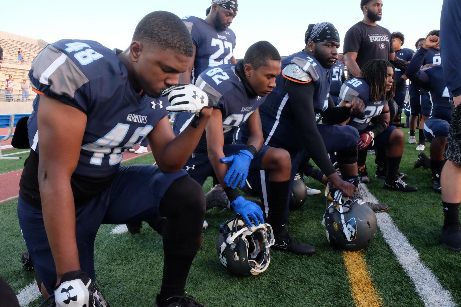 Football players kneel to raise awareness for racial injustice El