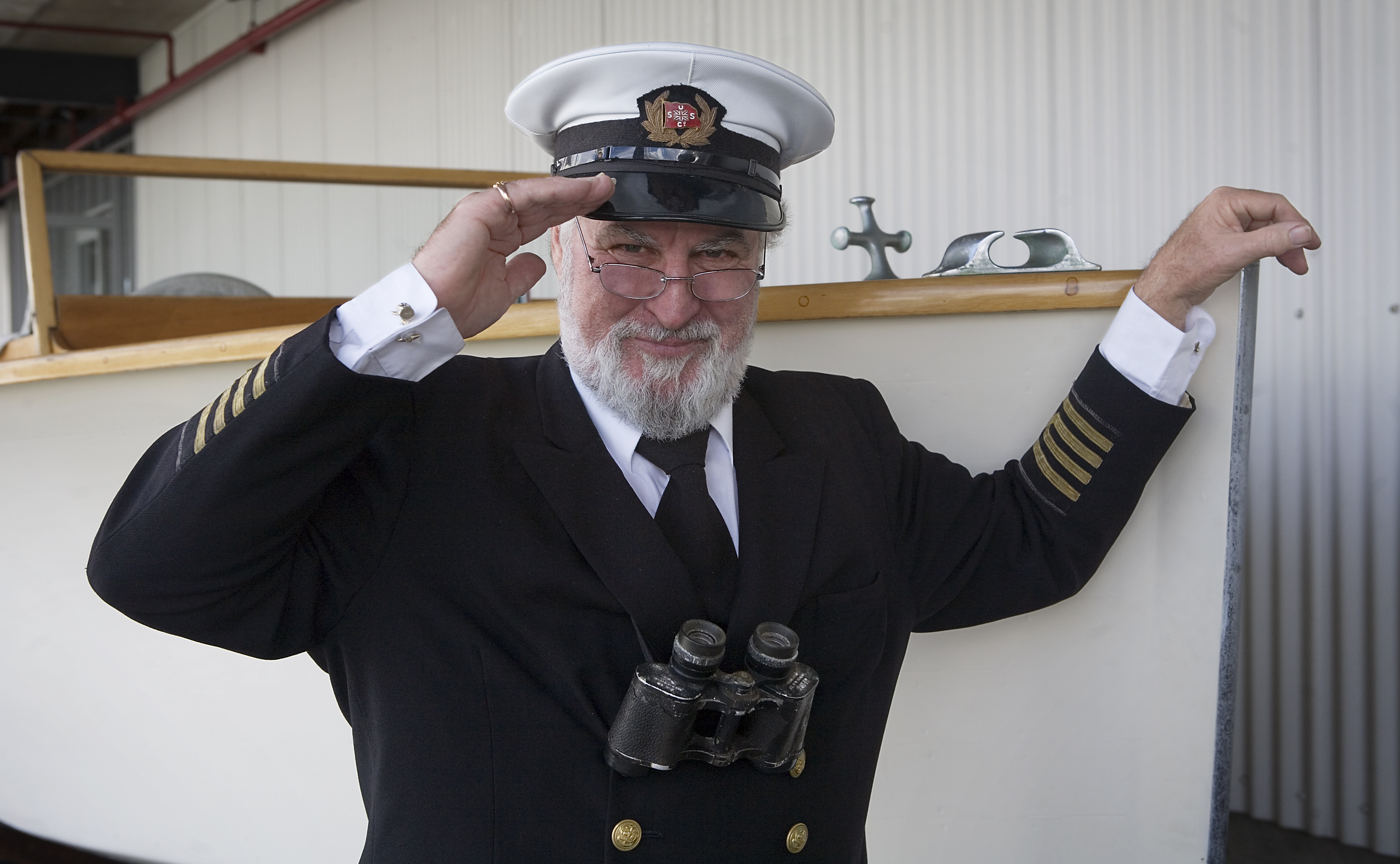 A veteran seaman in full captain uniform salutes. Auckland