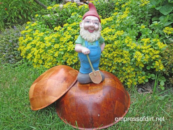 Garden gnome and wooden bowl.
