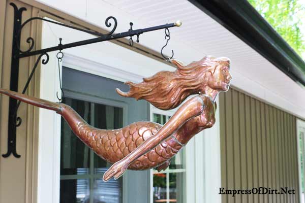 Rusty mermaid as garden art.