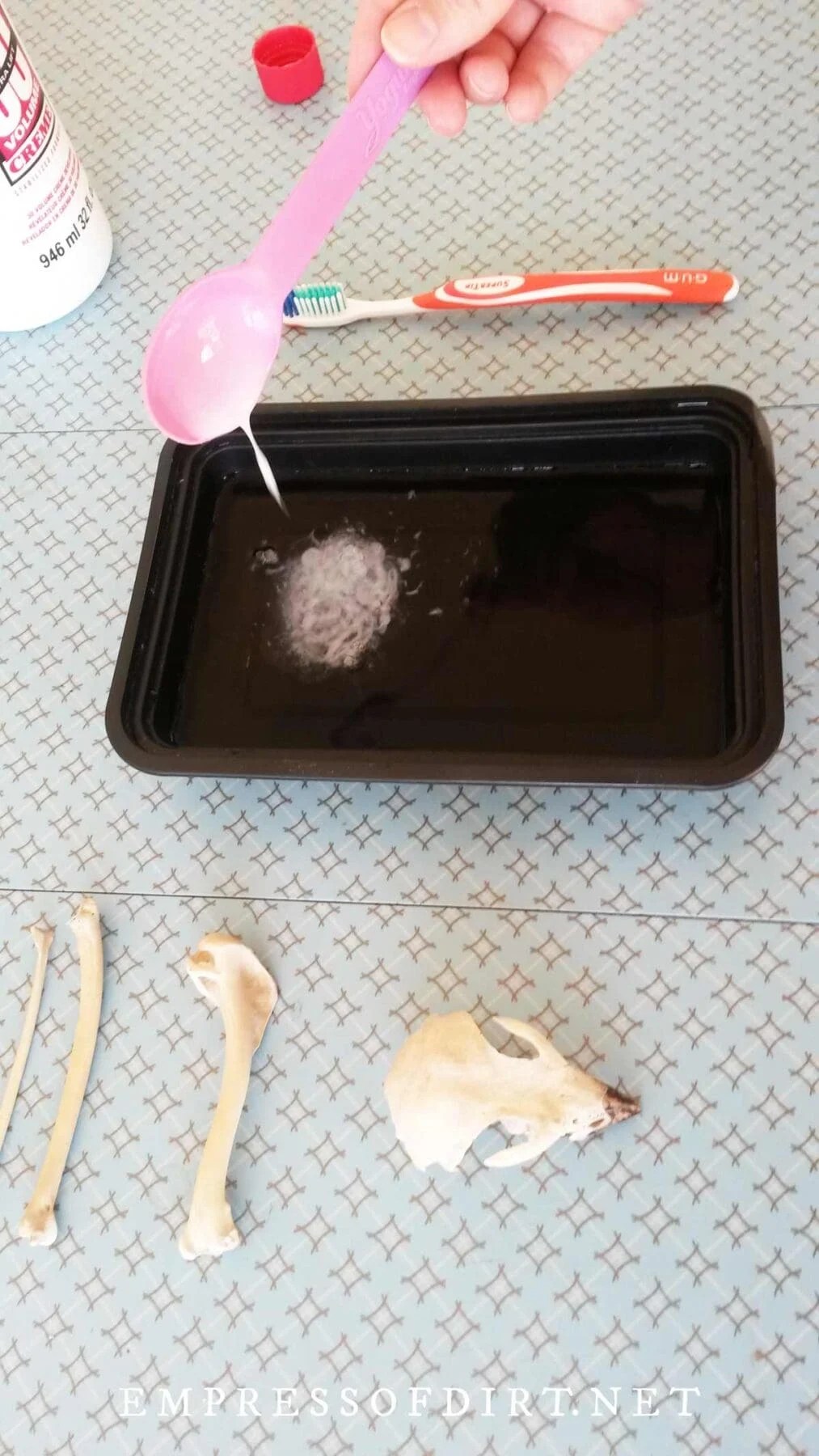 Adding cream developer to water tray.