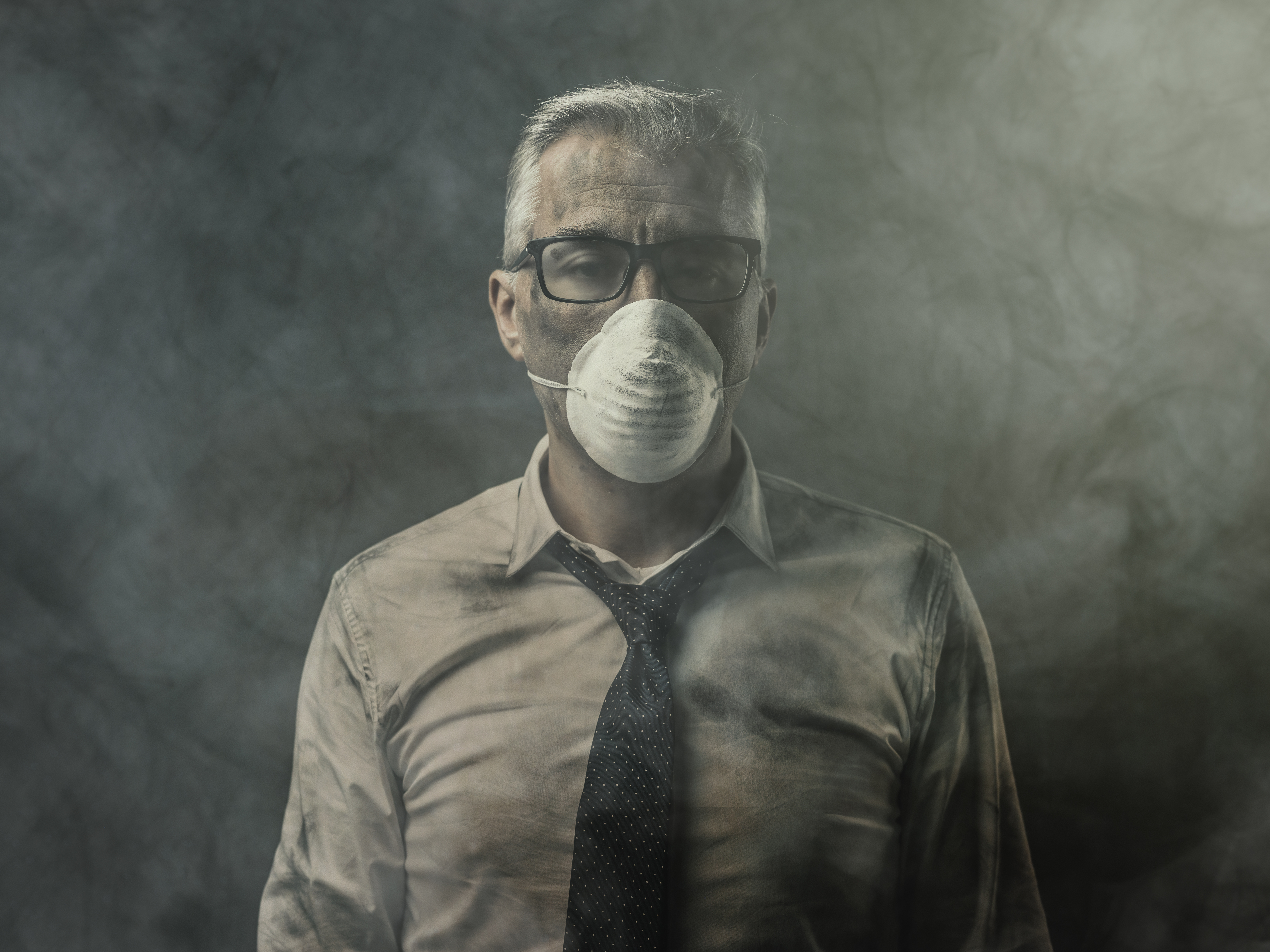Businessman with mask and air pollution Environmental Consultants
