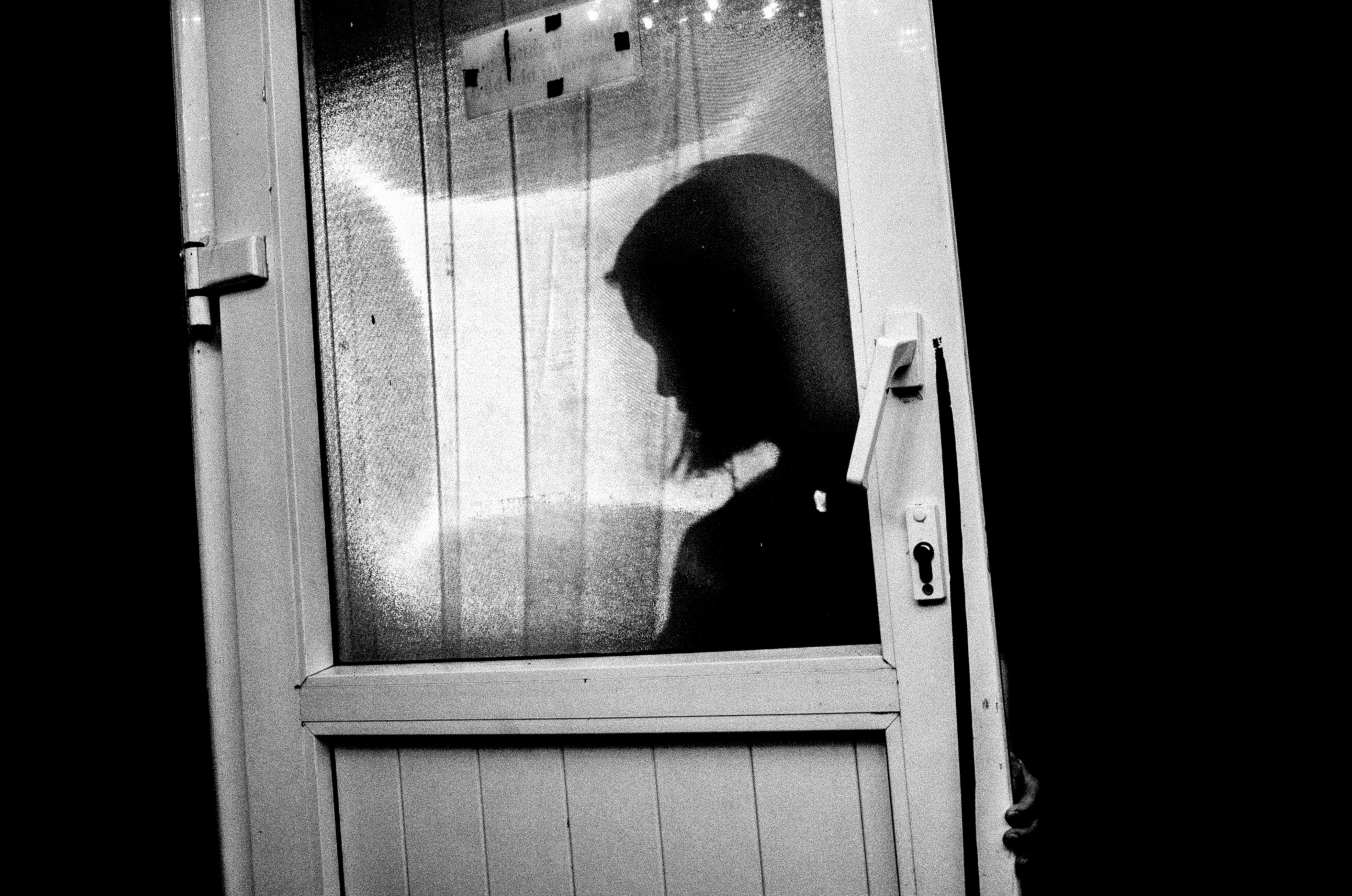 Hanoi, 2017. Shot of a silhouette of a woman at a coffee shop.