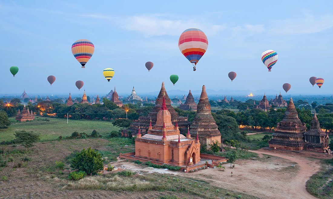 Colorful hot air balloons flying over Bagan Archaeological zone 