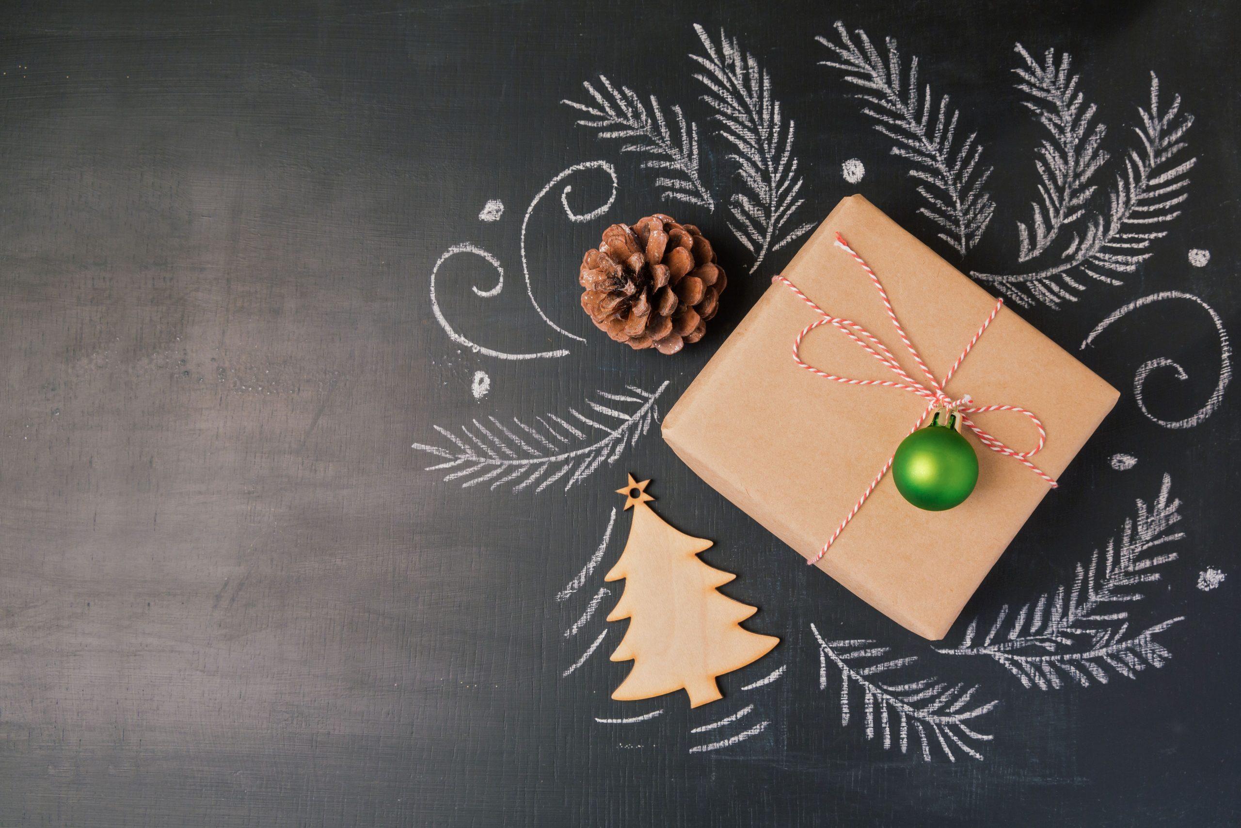 Christmas holiday gift on chalkboard background. View from above