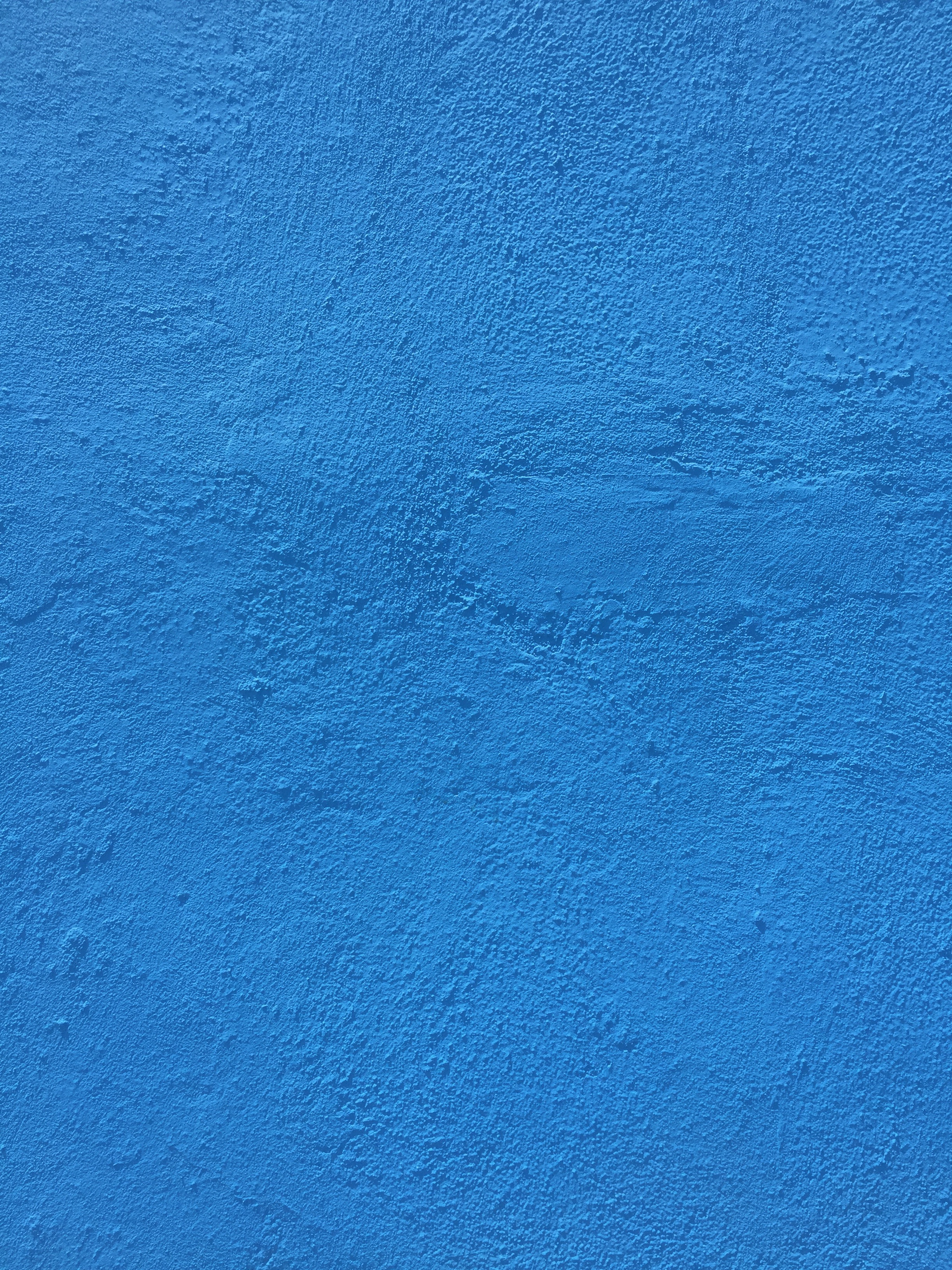 Bright blue paint over concrete wall Free Textures