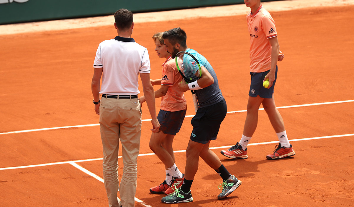 Watch Tennis star in horrors after smashing into ballboy during French
