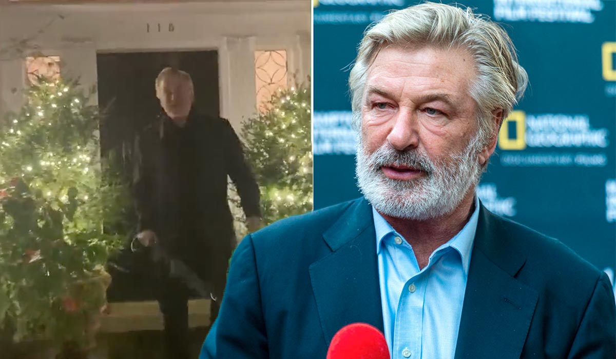 Watch Alec Baldwin marches at paparazzi waving umbrella as he's