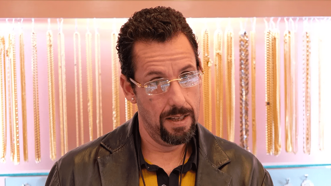 Adam Sandler looking on