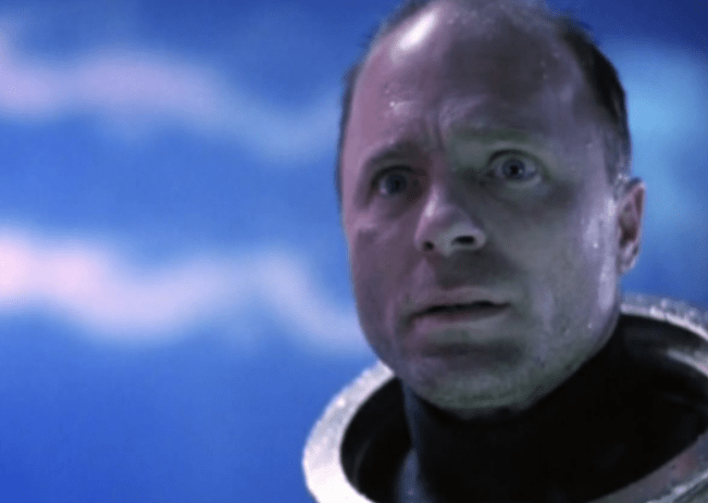 Ed Harris as Gene Kranz, staring in horror during a dramatic moment in the film.