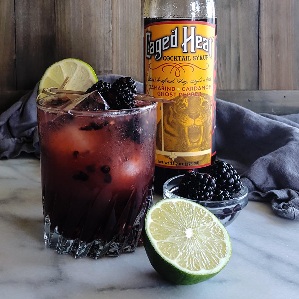 midsummer’s heat | a spicy blackberry bourbon smash featuring caged heat cocktail syrup