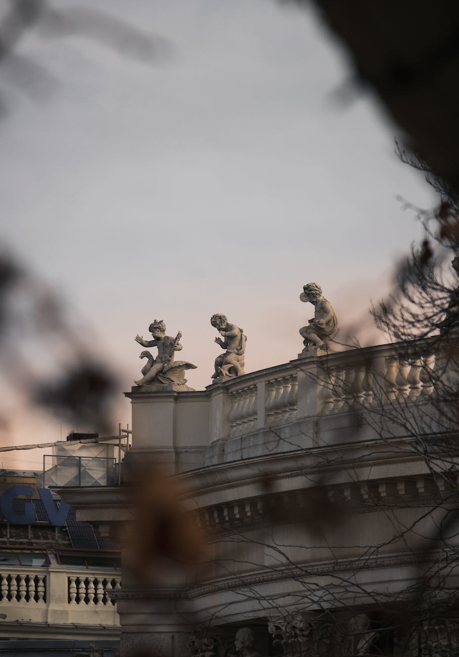concrete statues on top of the building