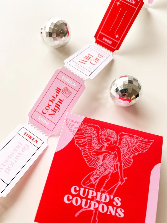 Red, white, and pink love coupons from Curated For You. A red card reads "Cupid's Coupons".